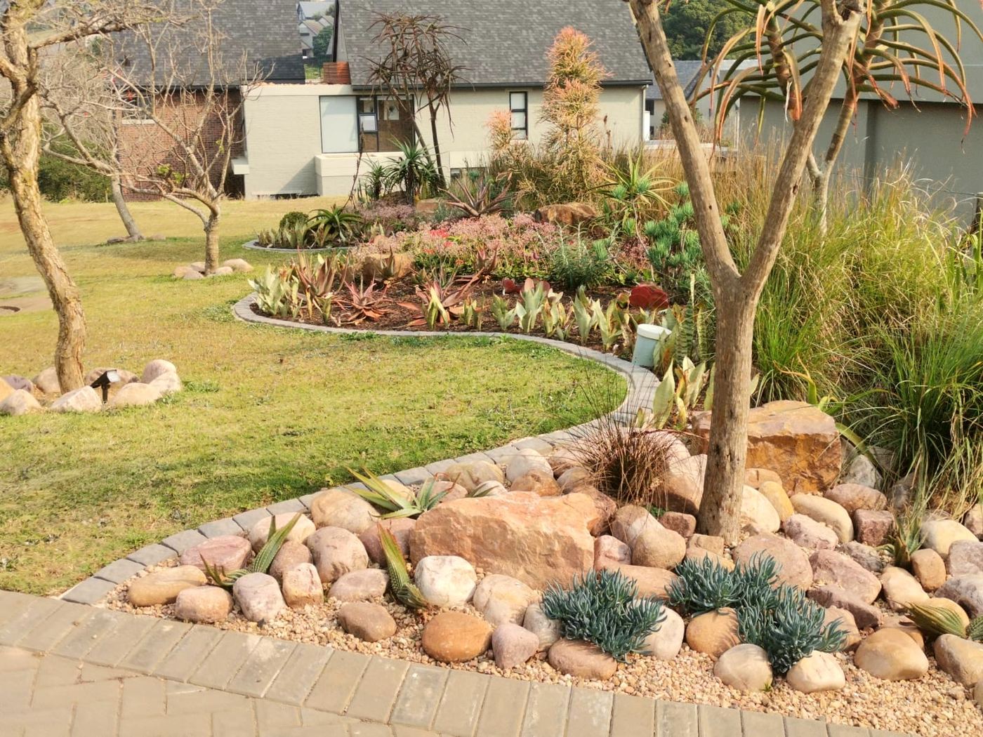 Rockery garden with indigenous succulents and curved edging in Hillcrest