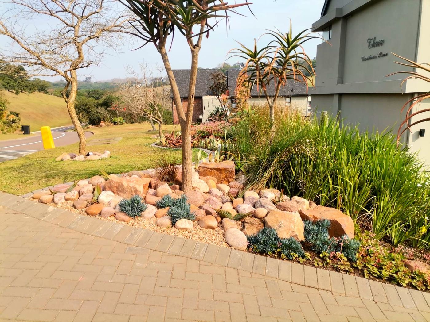 Rockery with aloes and river stones along driveway in Hillcrest